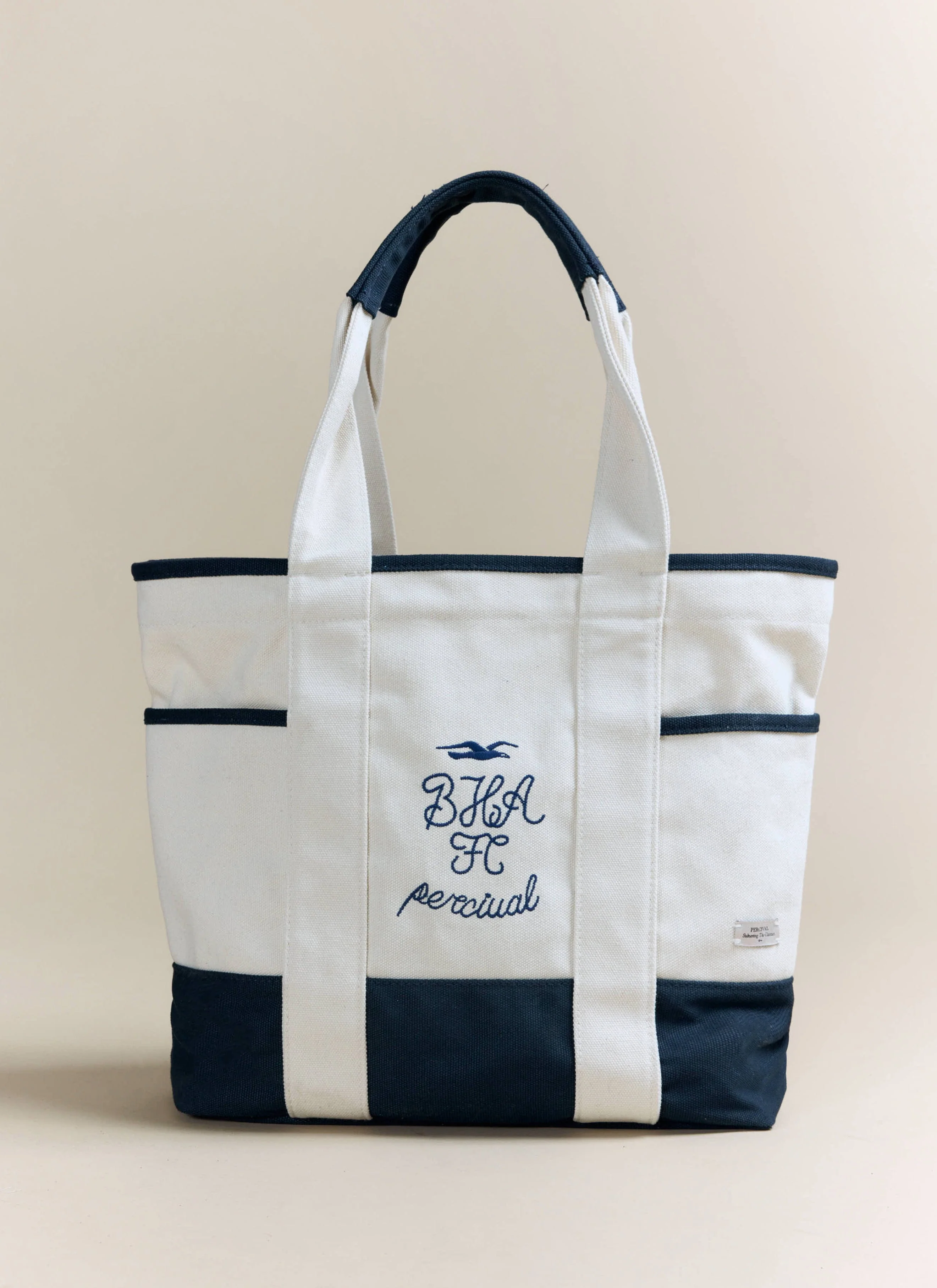 4031-tote-bag-brighton-hove-albion-f.c.-x-percival-cream-navy-1.webp Tote Bag | Brighton & Hove Albion F.C. x Percival | Cream Navy